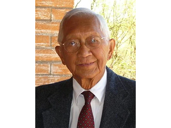 person wearing glasses, suit and tie