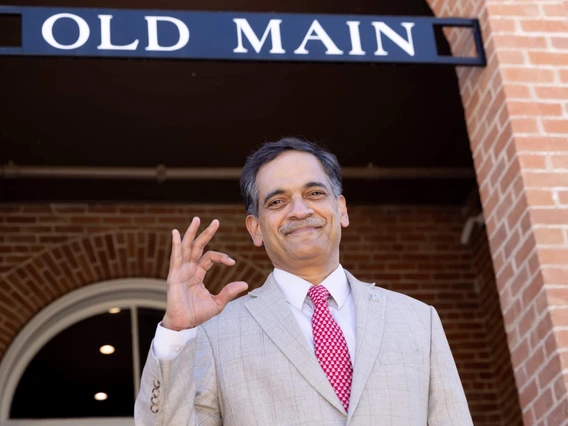 Suresh Garimella, 23rd president of the University of Arizona and a professor of aerospace and mechanical engineering, throws up a Bear Down in front of Old Main. 