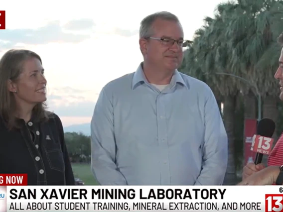 A woman and man are interviewed by a reporter