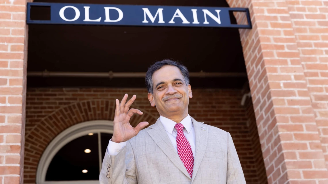 Suresh Garimella, 23rd president of the University of Arizona and a professor of aerospace and mechanical engineering, throws up a Bear Down in front of Old Main. 